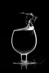 A glass of water, a splash of water