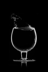 A glass of water, a splash of water