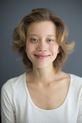 Portrait of young beautiful smiling woman happily looking in camera isolated