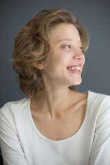Portrait of cheerful woman happily looking aside isolated