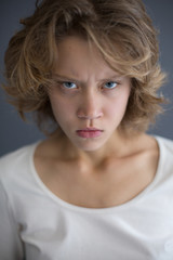Naklejka premium Portrait of young displeased lady angrily looking in camera isolated
