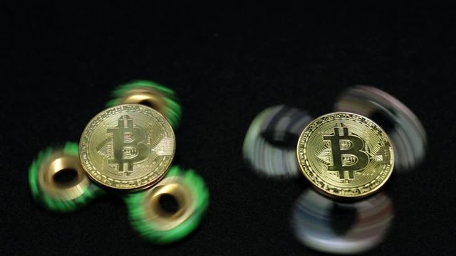 Rotating toy spiner and gold coin bitcoin.