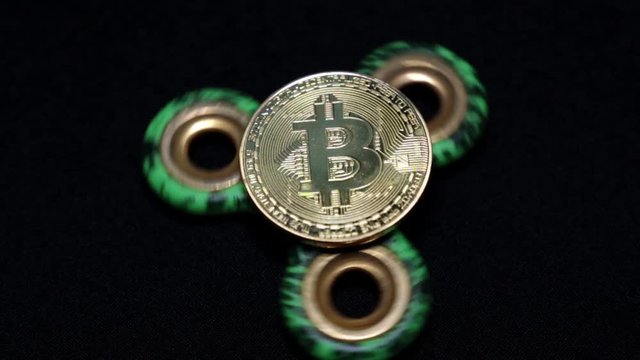 Rotating toy spiner and gold coin bitcoin.