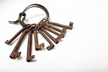 Nine large heavy iron keys on leather strap with copy space