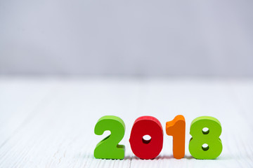 2018 colorful wooden text on white wooden desk with Christmas decorations, Merry Christmas and happy new year concept.