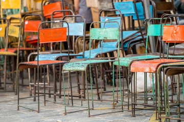 Rusted colorful old iron chairs