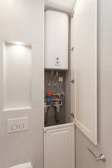 Electric Boiler with water filters in the .white shower room