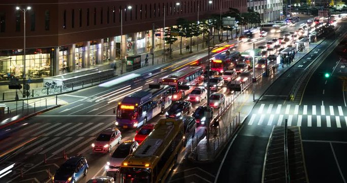 Traffic timelapse of a busy road and zebra crossing near Seoul station in South Korea.