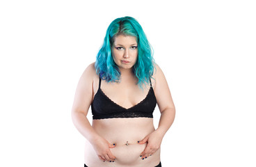 Fat girl. Sad overweight young woman pinching her fat midriff, abdomen. Pot belly, diet, weight problem

