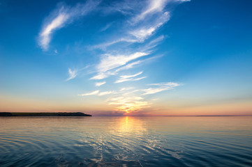 Fototapeta premium Sunset from light pinnate olives against the background of water. The edge of the hill