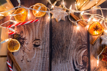 Christmas frame with lights, ornaments, candy and decorations. Free space