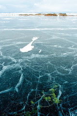 Frozen Lake Baikal. Beautiful mountain near the ice surface on a frosty day. Natural background