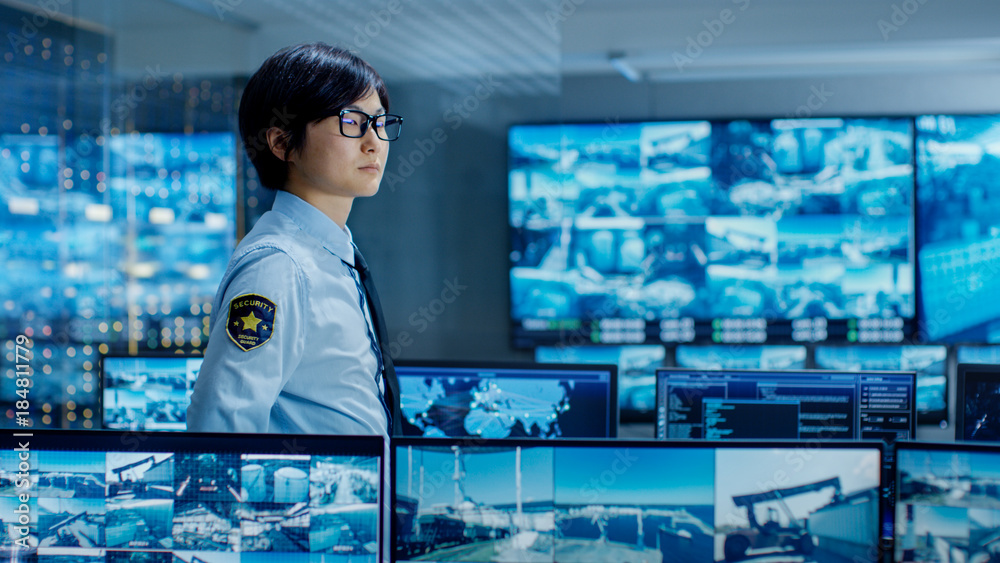 Poster in the security control room officer monitors multiple screens for suspicious activities. he guards 