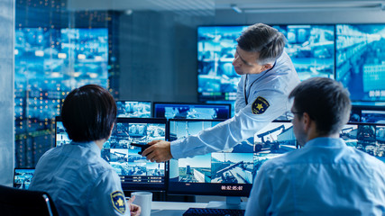 In the Security Control Room Chief Surveillance Officer Showing on Screen a Crime for Two of His...