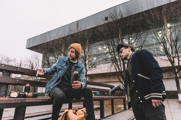 street artists holding cans with spray paint in city