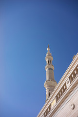 Fototapeta na wymiar MEDINA, SAUDI ARABIA - 16TH NOV 2017; External view of minaret for of Nabawi Mosque. Nabawi mosque is the second holiest mosque in Islam and built in 622.