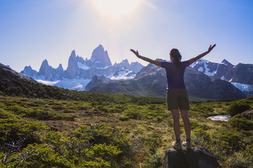 Fototapeta na wymiar Young woman is admiring the view of Fitz Roy in Patagonia region in Argentina