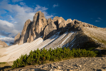 Last sun rays illuminating Tre Cime di Lavarado in Dolomite mountains, Italy, Europe