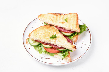 Sandwiches with salami, tomatoes, cucumber and lettuce
