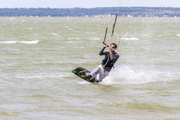 Kiteboarding. Fun in the ocean, Extreme Sport Kitesurfing. Closeup Darkslide.