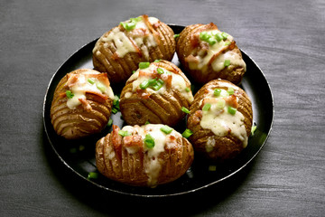 Baked potatoes with bacon, green onion and cheese