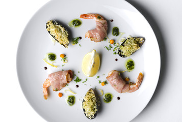 Shrimp and mussels grill on a white plate