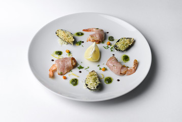 Shrimp and mussels grill on a white plate