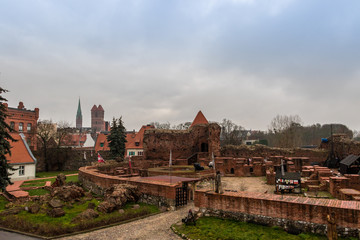 Torun cityscape with the ruins of the Teutonic Knights' Castle under the cloudy sky on a foggy morning. Listed on the UNESCO World Heritage Site. © irena iris szewczyk
