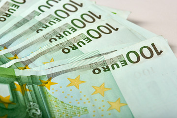 Obraz premium Euro money bank. Rolled up Euro bills on white background. One hundred and 50 Euro bills