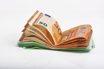 Euro money bank. Rolled up Euro bills on white background. One hundred and 50 Euro bills