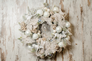 Stylish Christmas wreath made of fir tree and decorated in white tones