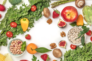 Vibrant fresh vegetables, fruits, cereals, and mushrooms on white background with copyspace