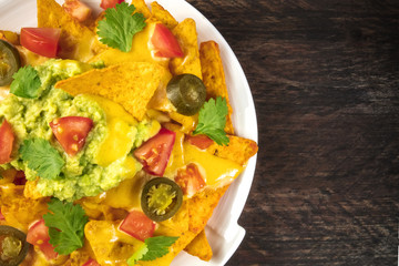 Nachos with cheese, traditional Mexican snack, with copyspace