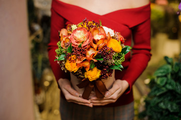 Woman holding a box with a flower composition for the Valentines day