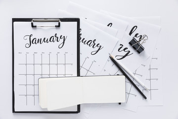 top view of arrangement of office supplies and calendar isolated on white