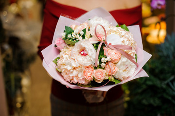 Woman holding a tender bouquet of pink flowers for the Valentine s day