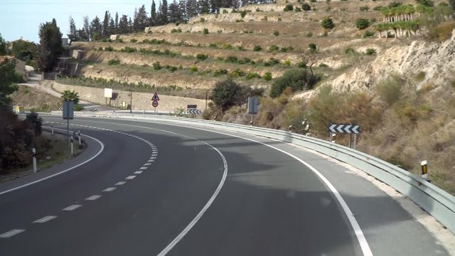 A view of the road in Andalusia, Spain from the bus front window. Bus going to Malaga.