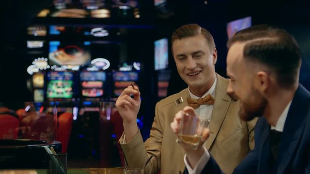 Men gamblers talking in a casino