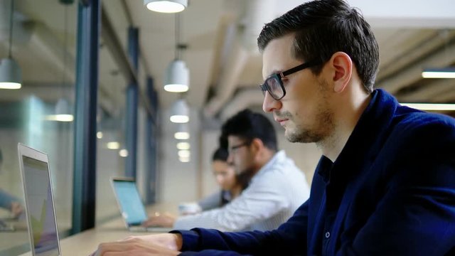 Young independent speacialists in coworking office 