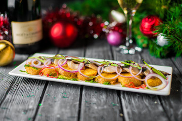 Herring in oil with greens on a New Year's table