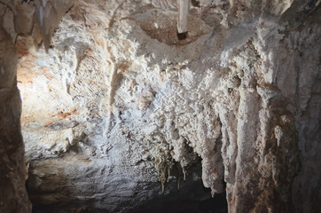 Stalactite formations on the ceiling of a grotto.
