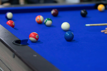 Blue Pool table with balls. This is sports.