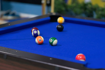 Blue Pool table with balls. This is sports.