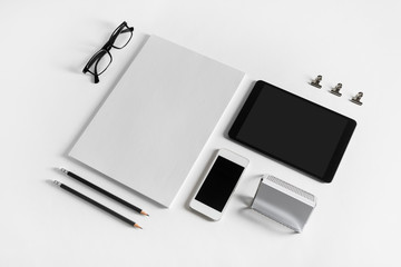 Brand identity template. Photo of blank corporate stationery and gadgets set on white paper background.