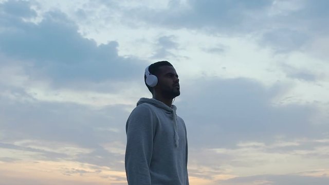 Handsome latin man looking into endless sky, searching for right way, freedom