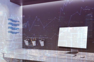 White screen coputer in a black office, graphs