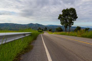 rural asphalt road ahead to the mountain