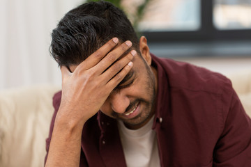 close up of man suffering from head ache at home