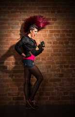 Punk girl on brick wall background