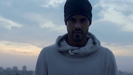 Strong latin man raising his eyes, he is determined to go and fight for goals